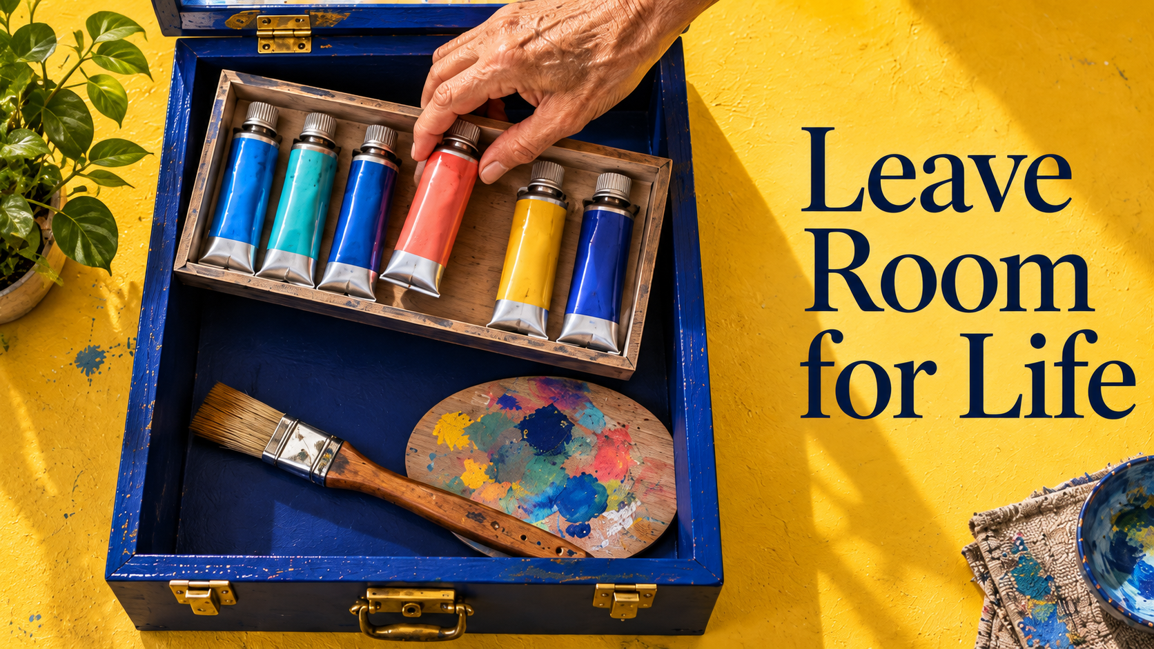 An older hand selects a coral paint tube from a blue artist’s box.