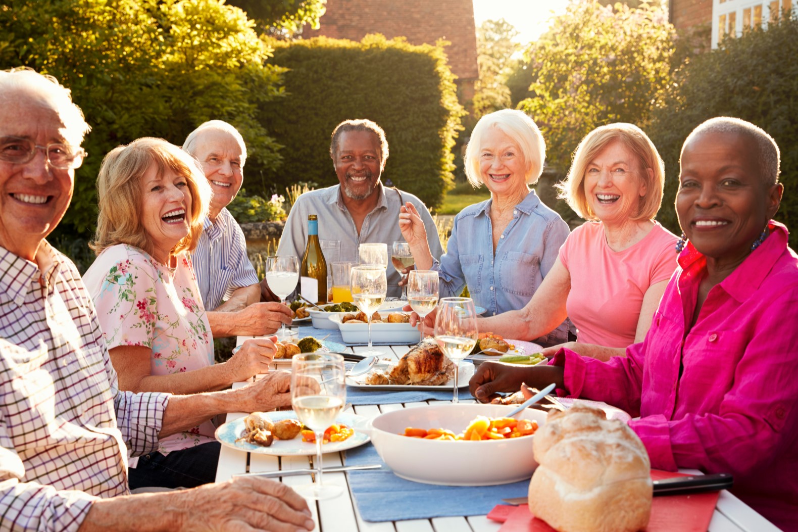 Portrait Of Senior Friends Enjoying Outdoor Dinner