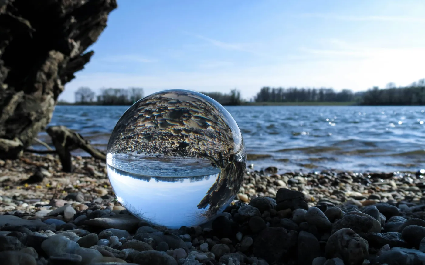 body of water on rocky shore by Niclas Dehmel courtesy of Unsplash.