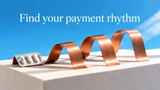 A copper ribbon forms gentle waves beside a medicine blister pack under the words “Find your payment rhythm.”