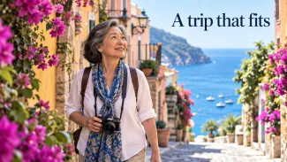 A woman with a camera explores a colorful seaside village beneath the words “A trip that fits.”