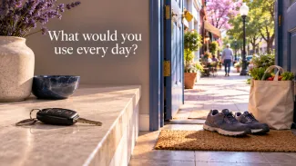 Car keys rest beside an open doorway, walking shoes, and groceries beneath the words “What would you use every day?”
