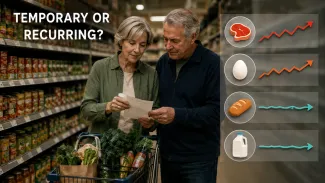 An older couple compares a grocery list as category icons show some prices rising while others remain steady.