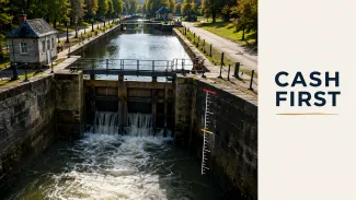 A canal lock fills with incoming water beside marked thresholds and the words “Cash First.”