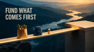 Groceries, a bag, and medication cross an illuminated bridge toward stable ground beneath the words “Fund What Comes First.”
