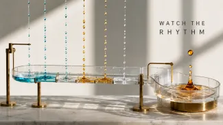 Timed blue, amber, and clear droplets flow through a channel toward a separate reservoir beneath the words “Watch the Rhythm.”