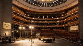 Temporary stage lights illuminate a theater while permanent house lights strengthen for later, representing portfolio support before Social Security begins.