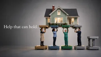 Four in-home service providers temporarily support a house while an unused platform stands ready as backup.