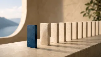 A row of upright stone blocks with one blue block set slightly apart, suggesting how one income decision can affect what follows.