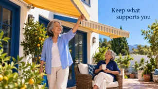An older woman adjusts a yellow awning while her companion relaxes in the shade. Text reads: Keep what supports you.