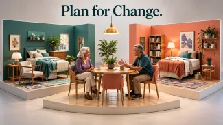 An older mother and adult son discuss shared living at a table between two distinct, comfortably furnished personal spaces.