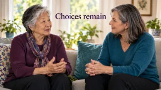 An older woman speaks with a female adviser in a sunlit room beneath the words “Choices remain.”
