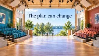 A sunlit performance space with an open floor and colorful seating, with the words “The plan can change.”
