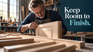 A craftsman inspects an unfinished cabinet door in a sunlit workshop, with the words “Keep Room to Finish.”