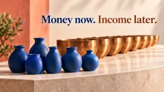 A cluster of blue ceramic vessels sits beside a receding row of copper bowls beneath “Money now. Income later.”