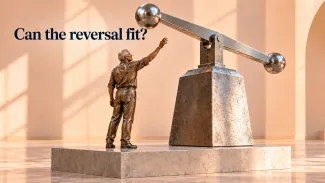 A bronze worker reaches toward a large weighted lever beneath the question “Can the reversal fit?”