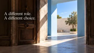 A dark wooden doorway opens toward a sunlit blue entrance and courtyard beside the words “A different role. A different choice.”