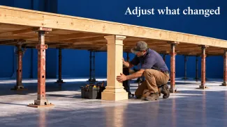 A worker installs a wooden support beneath a platform while surrounding supports remain, beneath “Adjust what changed.”