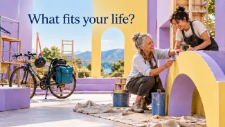 An older woman and a younger colleague paint colorful stage scenery beside a touring bicycle, beneath the words “What fits your life?”