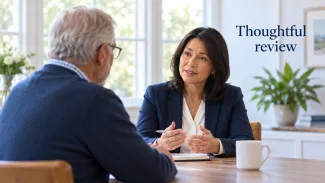 An older man speaks with a professional about a family trust request, beside the words “Thoughtful review.”