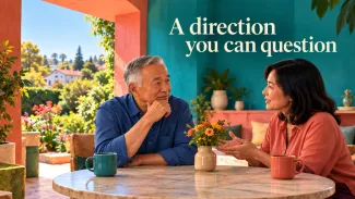 An older man considers an advisor’s explanation in a colorful room overlooking a neighborhood garden, beneath the words “A direction you can question.”