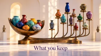 A bronze sculpture holds colorful ceramic vessels together in one cradle and separately on individual supports, with the words “What you keep."