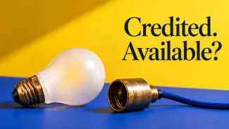 A disconnected lightbulb and brass socket rest on a blue surface beneath the words “Credited. Available?”