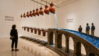 A gallery installation shows measured water streams feeding a permanent aqueduct when pension payments begin.