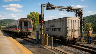A passenger train departs while a separate cargo car marked “Final Contribution?” remains at an inspection gate.