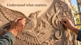 Two people shape a stone mural featuring a bird and musical notes beneath the words “Understand what matters.”