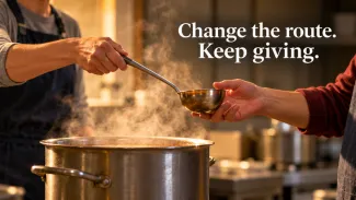 Two volunteers hold a ladle above a steaming pot beneath the words “Change the route. Keep giving.”