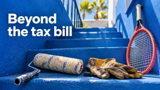 A paint roller and work gloves rest beside a tennis racket on vivid blue stairs beneath the words Beyond the tax bill.