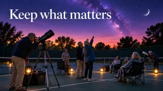 Older adults gather around telescopes on a tennis court at dusk beneath the words “Keep what matters.”
