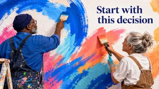 Two older adults paint blue and coral strokes on a shared mural beneath the words “Start with this decision.”