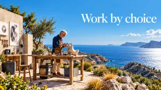 An older man sculpts at a workbench overlooking the sea beneath the words “Work by choice.”