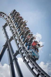 people riding on roller coaster during daytime by Itai Aarons courtesy of Unsplash.