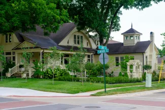 A charming yellow house with a porch and garden. by Far Chinberdiev courtesy of Unsplash.