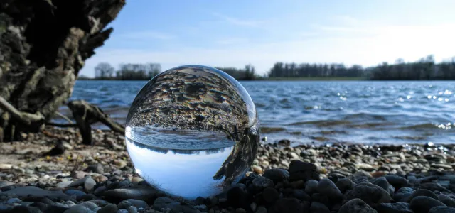 body of water on rocky shore by Niclas Dehmel courtesy of Unsplash.