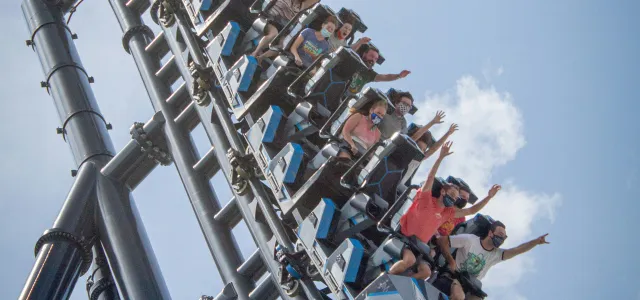 people riding on roller coaster during daytime by Itai Aarons courtesy of Unsplash.